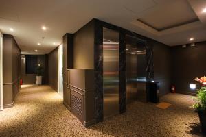 a corridor of an office with a refrigerator in a room at Christie Hotel 크리스티 호텔 in Seoul