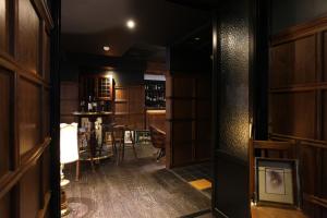 a dark room with a bar and a table at Christie Hotel 크리스티 호텔 in Seoul