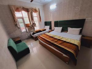 a bedroom with a bed and a couch in it at Pratap Resort in Katra