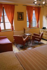 a bedroom with two beds and a table and chairs at Guest House Olšakovský in Český Krumlov +35 photos