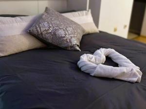 a rolled up towel on top of a bed at TauberGenuss in Werbach
