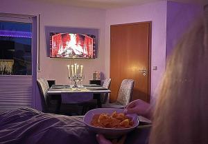 a woman sitting at a dining room table with a bowl of food at TauberGenuss in Werbach +36 photos