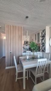 a dining room with a white table and chairs at 130 Brookes Hill Suites in Port Elizabeth