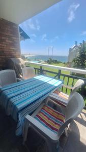 a table with a blanket and chairs on a balcony at 130 Brookes Hill Suites in Port Elizabeth