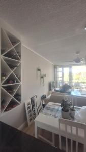 a living room with a table and a couch at 130 Brookes Hill Suites in Port Elizabeth