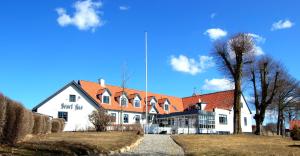 a large white building with a red roof at Sevel Kro in Vinderup