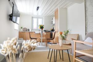 a living room and kitchen with a table and chairs at Anoi Kalymnos in Khoríon