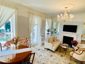 a living room with a table and a fireplace at Pier View Self Catering Luxury Apartments in Southend-on-Sea