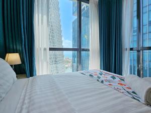 a bedroom with a bed with a view of a city at Evolve - Céleste in Colombo +27 photos