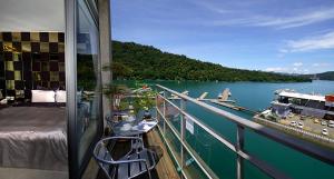 a balcony with a view of a boat on a lake at Lakeview Homestay in Yuchi