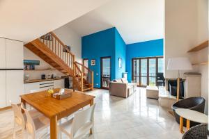 a kitchen and living room with a wooden table and chairs at Balcone di Noa e Stella in Menaggio