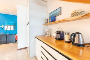 a kitchen with white cabinets and a wooden counter top at Balcone di Noa e Stella in Menaggio