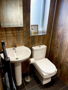 a bathroom with a white toilet and a sink at The View at 52, Whitby in Whitby +11 photos