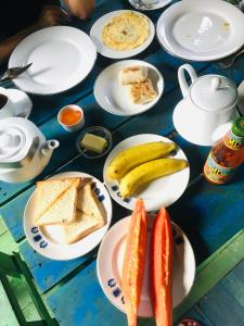 a blue table with plates of food on it at Matara Eco Friendly Treehouse in Matara +51 photos