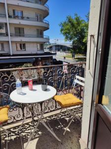 a white table and chairs on a balcony at Hôtel des Alpes in Annecy