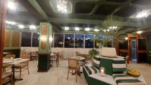 a restaurant with tables and chairs in a room at OrientalPalace Hotel in Manama