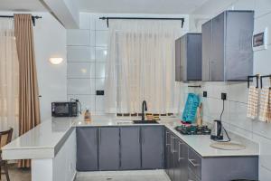 a kitchen with blue cabinets and a counter top at Diani Tulivu in Diani Beach
