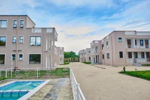 an apartment building with a pool in front of it at Diani Tulivu in Diani Beach