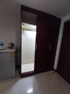 an open door to a kitchen with a refrigerator at Nana Hiso Hotel in Bangkok