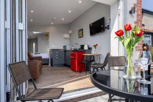a kitchen and living room with a table and chairs at The View at 52, Whitby in Whitby