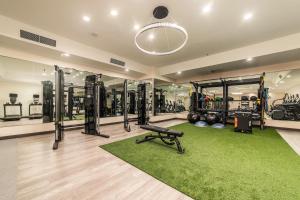 a fitness room with a gym with a treadmill at Hilton Garden Inn Clackamas Portland in Clackamas