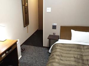 a bedroom with a bed and a desk and a mirror at Hotel Route-Inn Tsu Ekiminami -Kokudo23gou- in Tsu +30 photos