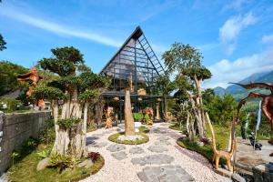 a building with trees in front of it at Luxcamp Selo - Merapi View by Horison in Selo