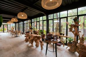 a large room with tables and chairs and windows at Luxcamp Selo - Merapi View by Horison in Selo