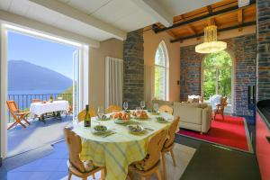 a dining room with a table and a living room at Villa Lucia Varenna in Varenna