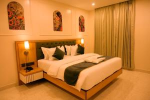 a bedroom with a large bed and a window at Hotel Grand Maspel in Dimapur +30 photos