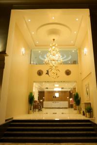 a large lobby with a chandelier and stairs at Hotel Grand Maspel in Dimapur