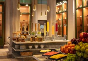 a buffet in a hotel with fruit on display at Anantara Palais Hansen Vienna - A Leading Hotel of the World in Vienna