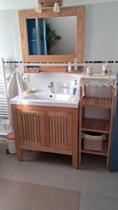 a bathroom with a sink and a mirror at Aux Volets Bleus in Sibiril +20 photos