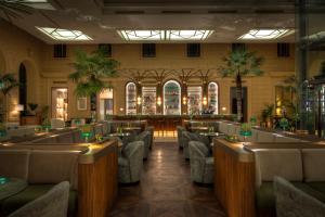 a restaurant with chairs and tables in a room at Anantara Palais Hansen Vienna - A Leading Hotel of the World in Vienna