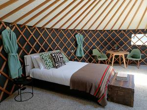 a bedroom with a bed in a yurt at The Round Tent Raglan in Raglan