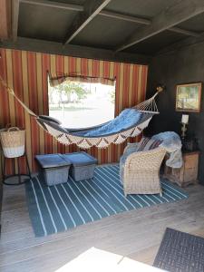 a hammock in a room with a bed and a window at The Round Tent Raglan in Raglan +9 photos