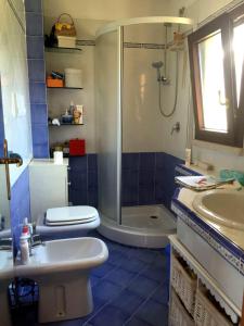 a bathroom with a shower and a toilet and a sink at La Chiave di Violino in Olbia