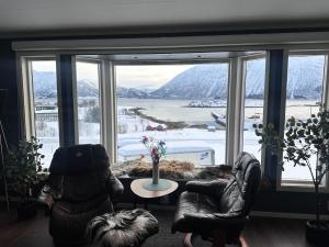 a living room with a large window with a view at Home with a view in Storholmen