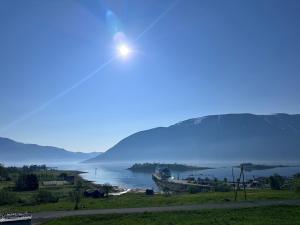 a view of a lake with mountains in the background at Home with a view in Storholmen +4 photos