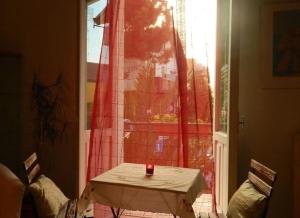 a candle sitting on a table in front of a window at Bed And Roses in Montesilvano