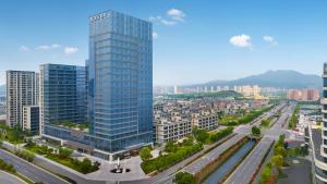 an aerial view of a city with a tall building at Maison New Century Ninghai Railway Station in Ninghai