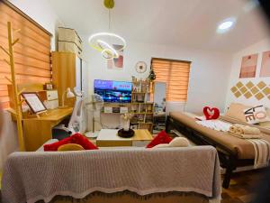 a bedroom with two beds and a desk in it at Olango Island - Tiny Guest House - S&E-3 in Lapu Lapu City