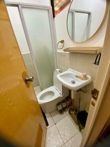 a small bathroom with a toilet and a sink at Olango Island - Tiny Guest House - S&E-3 in Lapu Lapu City +17 photos