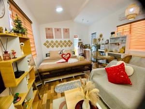 a living room with two beds and a kitchen at Olango Island - Tiny Guest House - S&E-3 in Lapu Lapu City