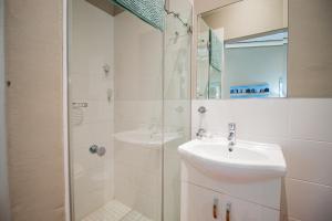 a white bathroom with a sink and a shower at Lekkerlag in Paternoster +14 photos