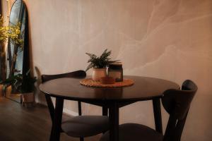 a table with a plant on it in a room at Chapel Street Hideaway in Melbourne