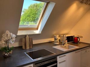 a kitchen with a sink and a window at Ferienwohnung 5 Anna in Bergen auf Rügen +12 photos