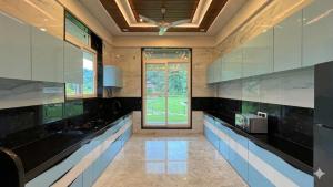 a kitchen with black and white counters and a window at Selborne Villas in Nagothna