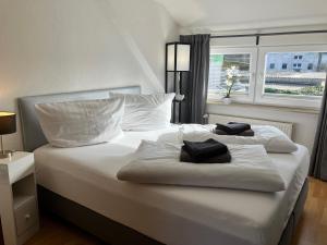 a bedroom with a white bed with two towels on it at Ferienwohnung 5 Anna in Bergen auf Rügen