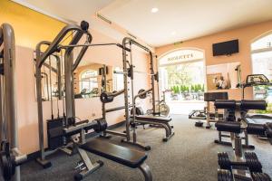 a gym with several treadmills and exercise bikes at Avenue Deluxe Hotel in Sunny Beach